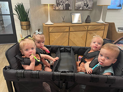 set of quadruplets practicing brushing teeth at their pediatric appointment at Smiles of Dripping Springs